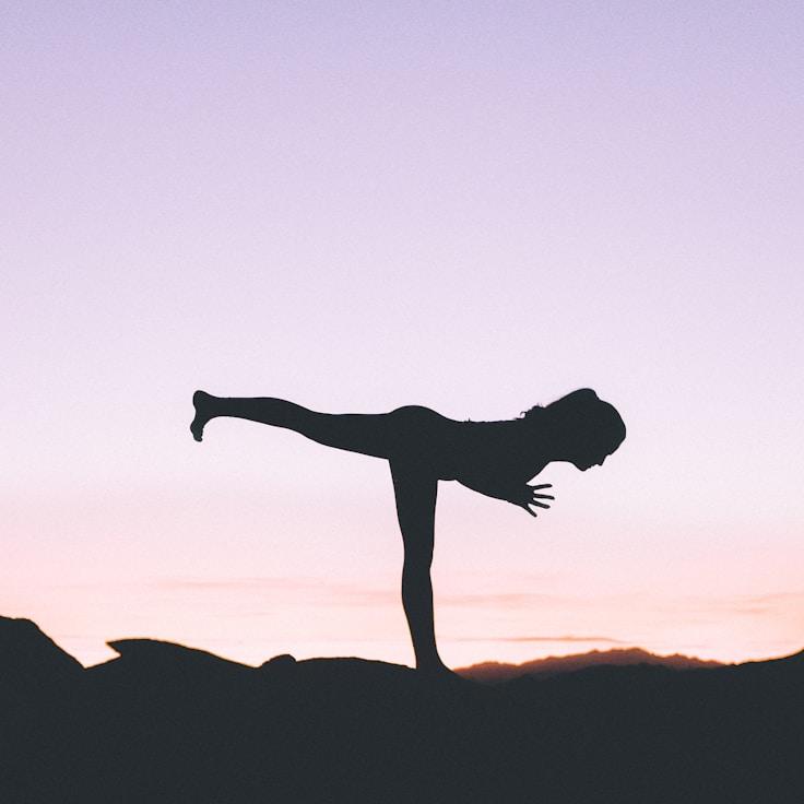 Women in a fitness class doing stretching and mobility exercises